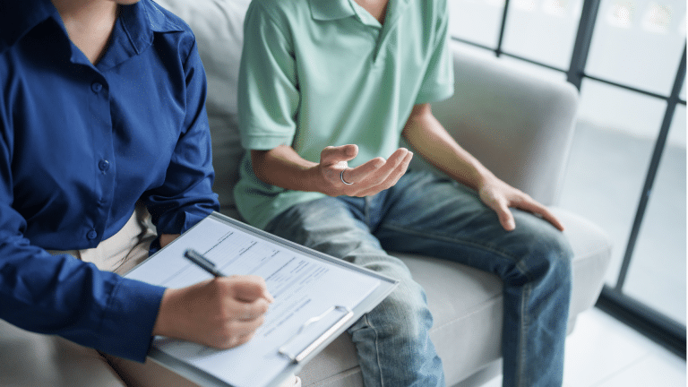 A family therapist taking notes during a counseling session in Tooele